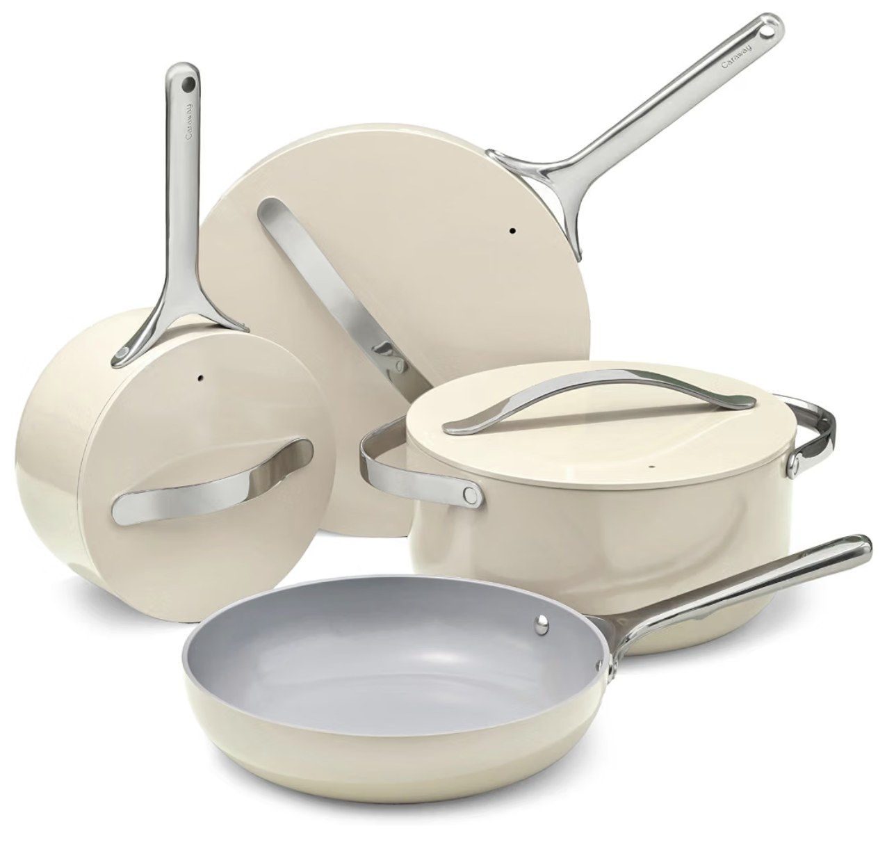 A cream Caraway non-stick ceramic cookware set with a fry pan, saucepan, sauté pan, and Dutch oven with lids